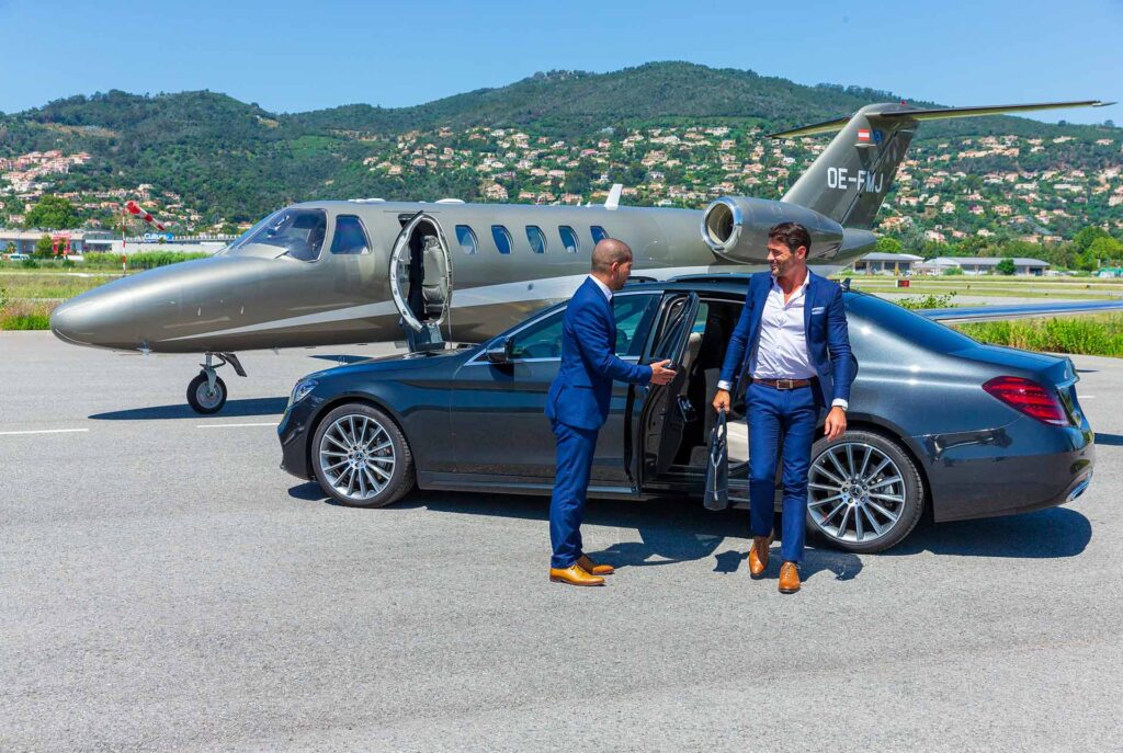 Luxury car with driver and guest in front of a privat jet 